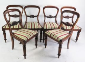 A Victorian Set of Six Mahogany Balloon Back Chairs with fluted legs and drop in seats