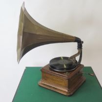 A table top wind-up gramophone with detachable flared horn and a small quantity of 78RPM records.