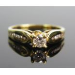 An 18ct Gold and Diamond Ring, 4.1mm principal brilliant round cut with eight further stones set