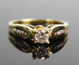 An 18ct Gold and Diamond Ring, 4.1mm principal brilliant round cut with eight further stones set