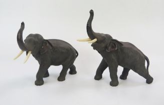 A Pair of Japanese Meiji Period Bronze Elephants with ivory tusks, both signed to the underside, and