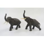 A Pair of Japanese Meiji Period Bronze Elephants with ivory tusks, both signed to the underside, and