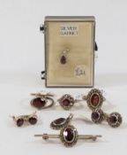 A circulat garnet and marcasite cluster ring and a pair of matching stud earrings, an oval garnet