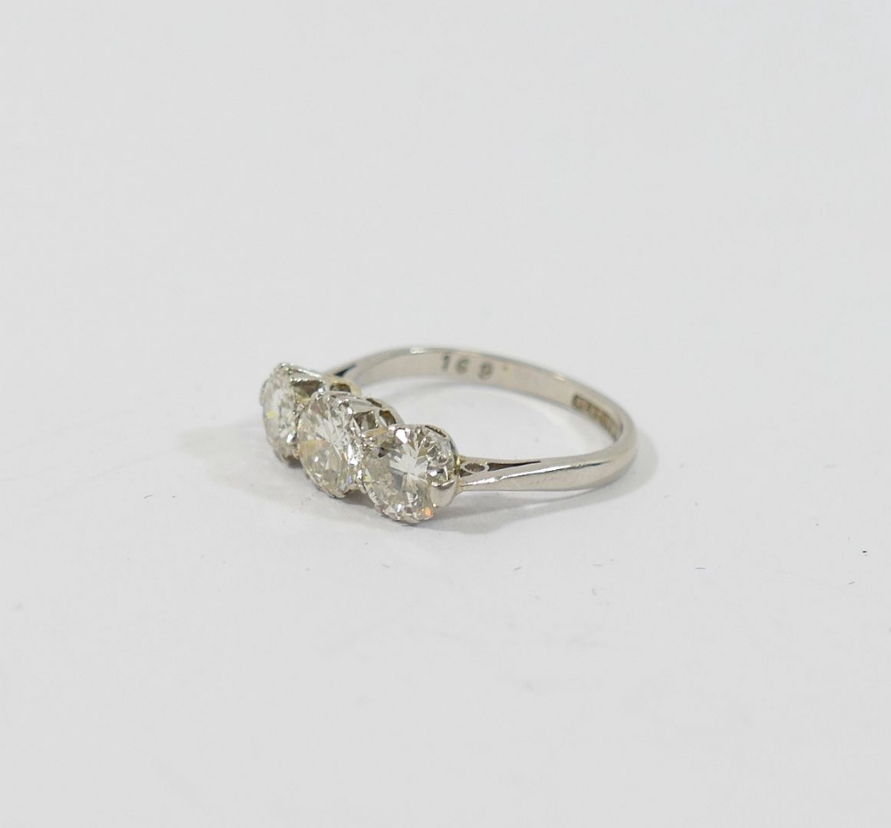 A mid-century platinum and diamond three-stone ring, the round brilliant cut stones combined - Image 2 of 5