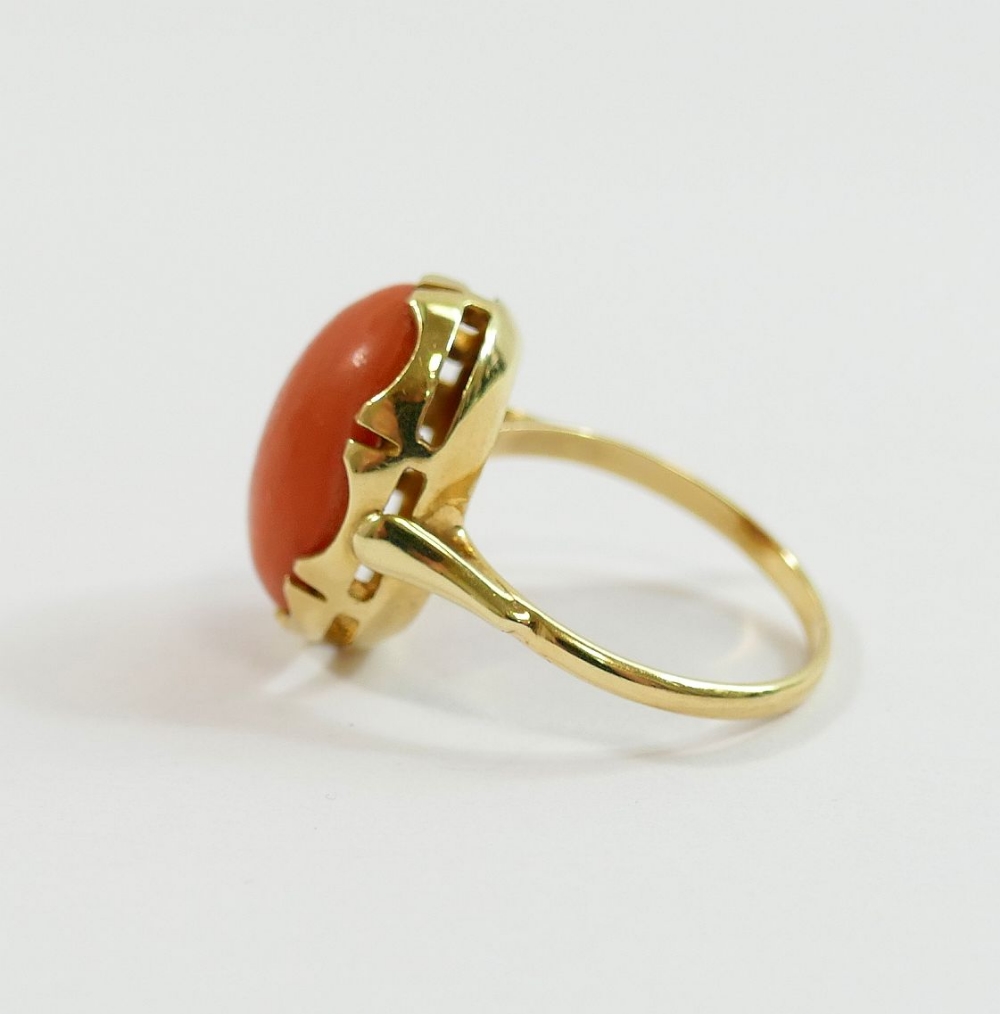 An oval coral cabochon in unmarked yellow metal ring mount, finger size K, 3.7g gross CONDITION - Image 2 of 3