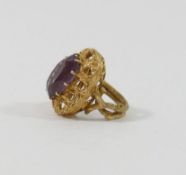A yellow metal amethyst single stone ring, the head of the ring 2.3cm x 1.8cm, the shank in the form