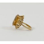 A yellow metal citrine set single stone ring, the head of the ring 2cm x 1.6cm, the shank stamped '