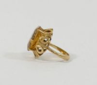 A yellow metal citrine set single stone ring, the head of the ring 2cm x 1.6cm, the shank stamped '