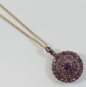 A late Victorian garnet circular cluster pendant, with removable gem-set bail and brooch fitting (