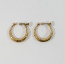 A pair of hollow hoop screw back earrings, stamped '9CT', 1.4g, and a pair of gold plated clip on