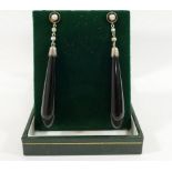 A pair of split pearl and onyx drop earrings, with stick backs, 6cm long, and a turquoise set cross,