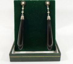 A pair of split pearl and onyx drop earrings, with stick backs, 6cm long, and a turquoise set cross,