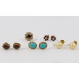 A pair of 9 carat gold turquoise set oval stud earrings, a pair of 9 carat gold garnet set oval stud