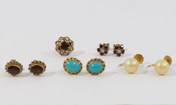 A pair of 9 carat gold turquoise set oval stud earrings, a pair of 9 carat gold garnet set oval stud