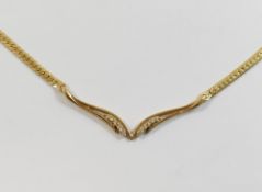 An Italian yellow metal wishbone necklace, stamped '14K', set with twelve eight-cut diamonds,
