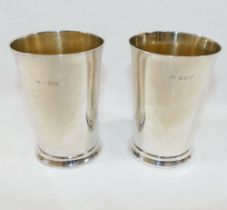 A pair of silver beakers by Elkington and Co., Birmingham 1920 and 1924, of plain straight sided
