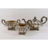 A William IV silver three-piece melon-shaped teaset, the teapot with lobed body raised on four