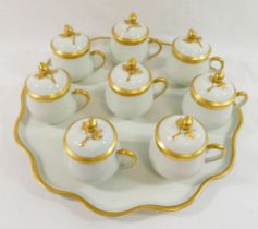A set of eight Limoges porcelain two-handled chocolate pots, the covers with rose bud finials, the