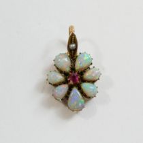 A late Victorian opal and garnet flower head pendant, the central eight-cut garnet within seven