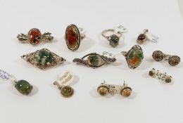 A collection of moss agate set silver and silver coloured metal jewellery, comprised of three rings,