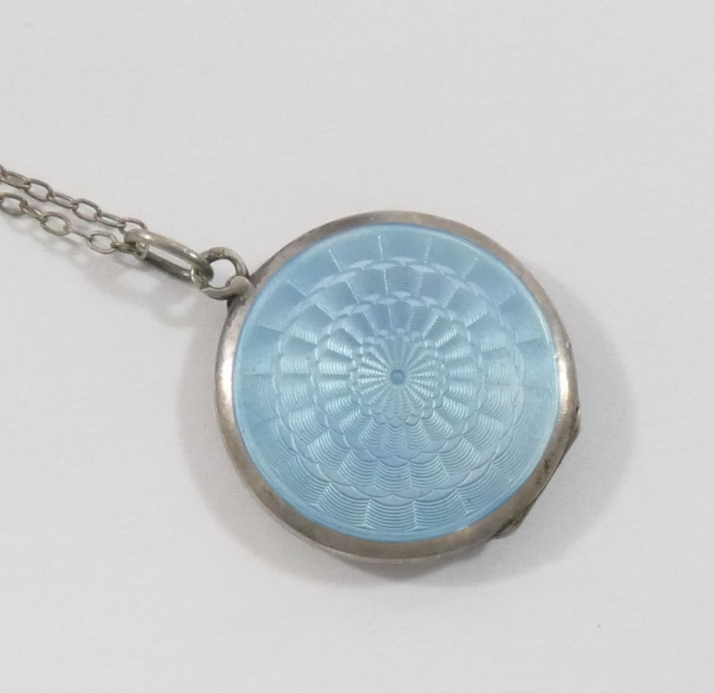 An early 20th century circular guilloche enamel locket, the powder blue ground hand painted with - Image 2 of 3