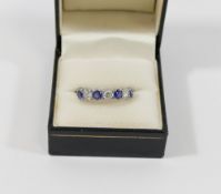 A sapphire and diamond half hoop ring, the three round brilliant cut diamonds each approximately 0.