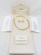 A French gold-plated collar necklace with accompanying half hoop earrings by Altesse CONDITION