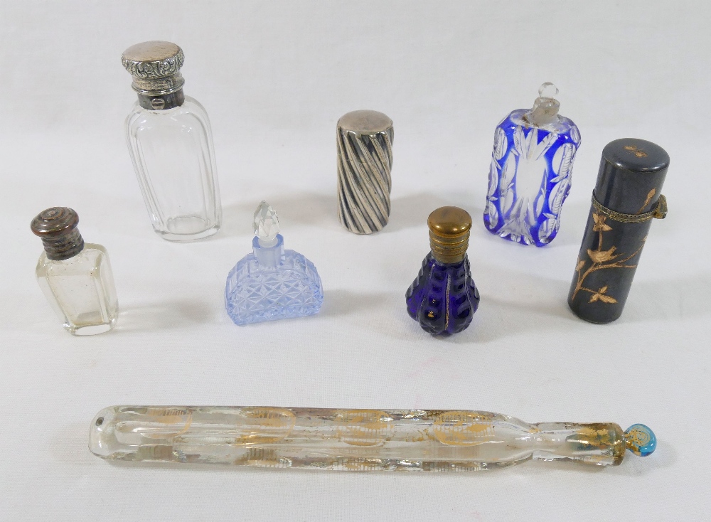 A collection of eight 19th century scent bottles, comprised of a silver topped panelled glass