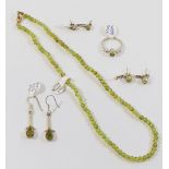 A small collection of peridot jewellery comprised of a beaded necklace, two pairs of stud