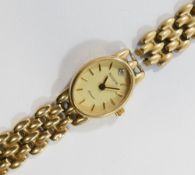 A 9 carat gold ladies Accurist bracelet watch, the oval face with baton markers and an eight-cut