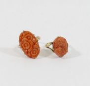 A oval carved coral panel, claw set to a yellow metal ring mount, the shank stamped '9CT', finger