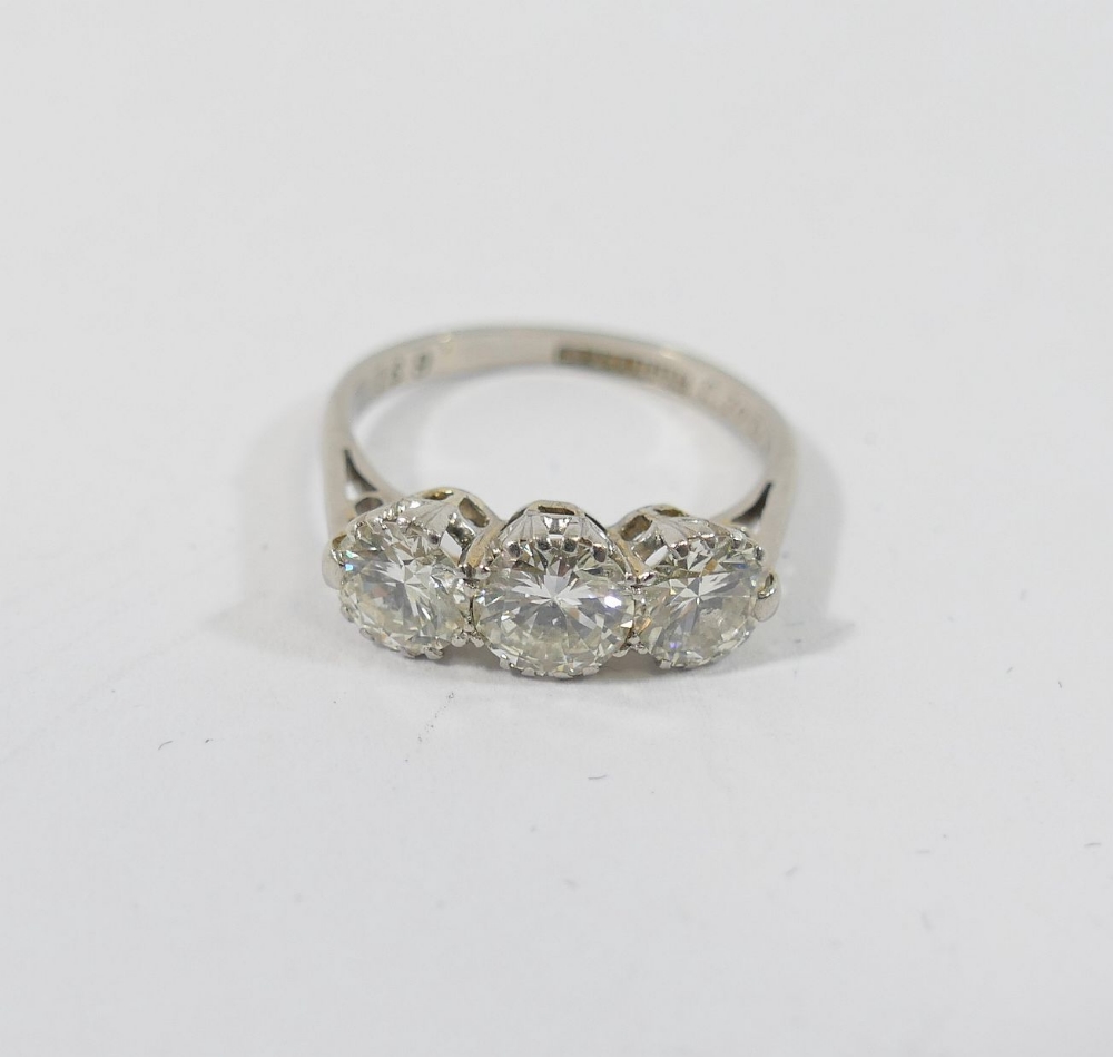 A mid-century platinum and diamond three-stone ring, the round brilliant cut stones combined - Image 3 of 5