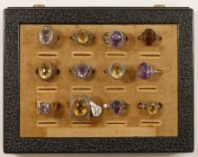 Twelve amethyst and citrine set single stone rings, ten stamped 'SILVER' one stamped '935' and one