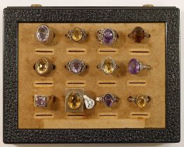 Twelve amethyst and citrine set single stone rings, ten stamped 'SILVER' one stamped '935' and one