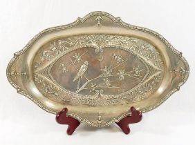 A cartouche-shaped Aesthetic movement silver dressing table tray, Birmingham 1911, embossed with