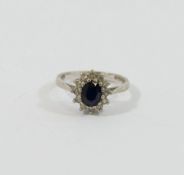 A white gold oval sapphire and diamond cluster ring, London 1975, the twelve eight-cut diamonds each