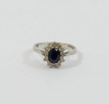 A white gold oval sapphire and diamond cluster ring, London 1975, the twelve eight-cut diamonds each