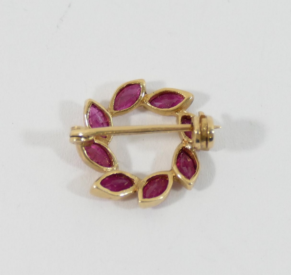 A small circular yellow metal laurel leaf brooch, set with rubies, import marks for London 1989, 1. - Image 2 of 2