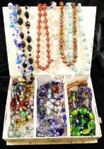 Early 20th century paste and wire necklaces, strings of glass beads and hardstone beads, housed in a