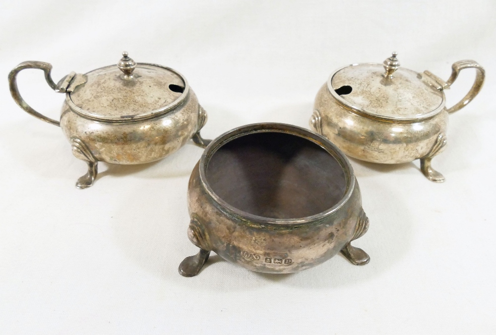 A pair of George V silver circular mustard pots, raised on hoof feet, and a matching salt, - Image 2 of 2