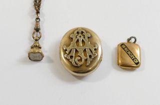 A large Victorian gold plated oval locket brooch with raised intertwined initials to the front, 3.
