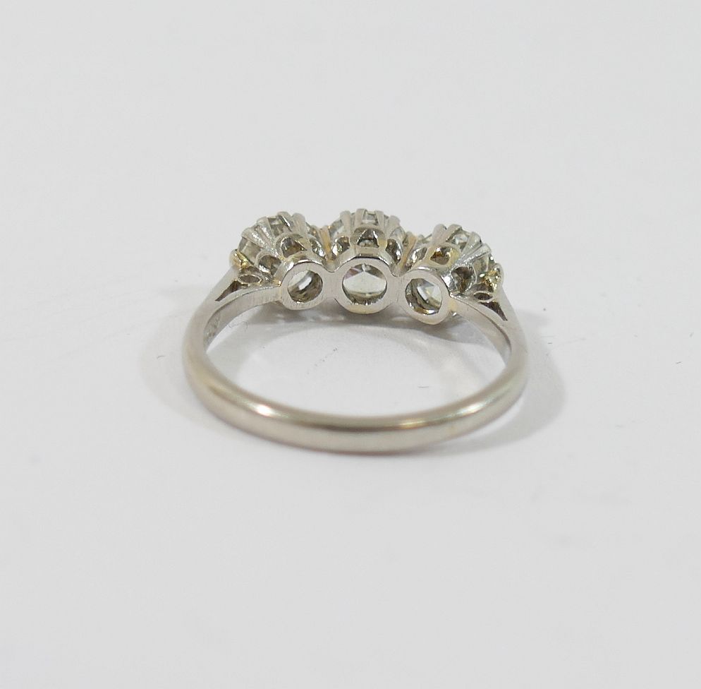 A mid-century platinum and diamond three-stone ring, the round brilliant cut stones combined - Image 5 of 5