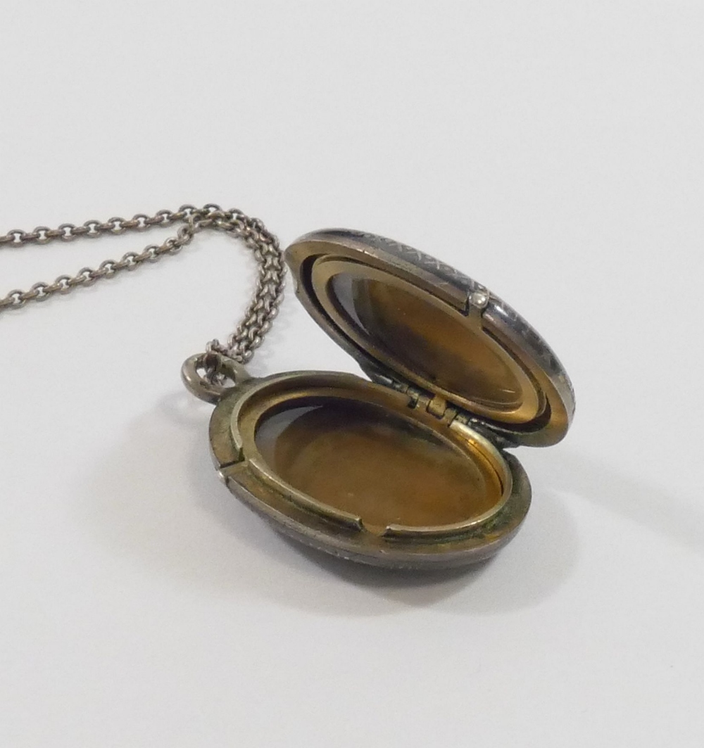 A 19th century oval niello locket on chain, the locket 2.5cm wide CONDITION REPORTS & PAYMENT - Image 3 of 3