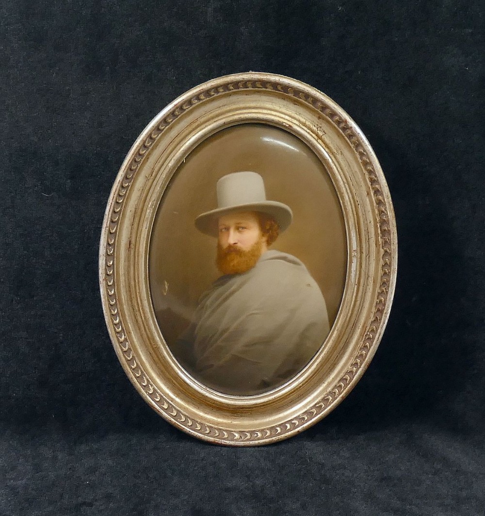 A late 19th century Continental oval porcelain plaque painted with a man wearing a grey cloak and - Image 2 of 3