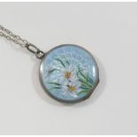 An early 20th century circular guilloche enamel locket, the powder blue ground hand painted with