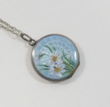 An early 20th century circular guilloche enamel locket, the powder blue ground hand painted with