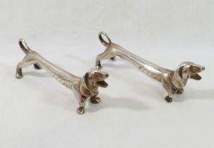 A pair of silver plated knife rests modelled as Dachshunds, unmarked, 7.8cm long CONDITION REPORTS &