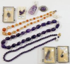 A quantity of amethyst jewellery comprised of a string of large pebble beads, a string of