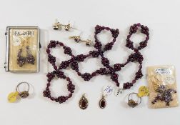 An assortment of garnet jewellery, mostly almandine, comprised of two rings, a beaded cluster