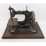 A Singer Manufacturing Company model 30K chain stich sewing machine, on a matching cast iron base,